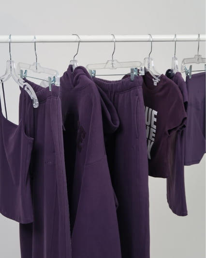 Hallie Batchelder wears a purple t-shirt and matching sweats.
