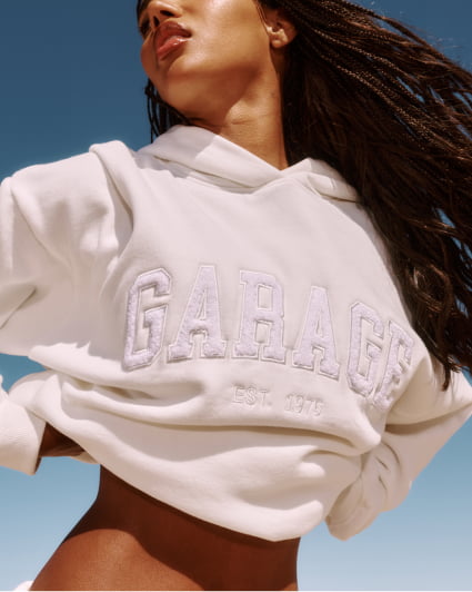 Model in a dark grey active top and matching sweats.